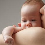 Why does regurgitation occur in newborns?